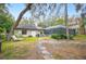 Landscaped backyard oasis with a stone path leading to a screened pool at 1423 Royal Forest Loop, Lakeland, FL 33811