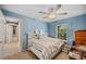 Bedroom with a queen bed, built-in shelves, and ensuite bathroom at 1423 Royal Forest Loop, Lakeland, FL 33811