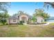 House exterior showcasing a well-maintained lawn and a swing at 1423 Royal Forest Loop, Lakeland, FL 33811