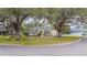 Single-story house with circular driveway and lush landscaping at 1423 Royal Forest Loop, Lakeland, FL 33811