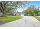 Single-story house with attached garage and a large driveway at 1423 Royal Forest Loop, Lakeland, FL 33811