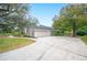 Single-story home with attached garage and a spacious driveway at 1423 Royal Forest Loop, Lakeland, FL 33811