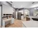 Spacious kitchen with white cabinets, gray walls, and a built-in desk at 1423 Royal Forest Loop, Lakeland, FL 33811