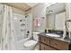 Bathroom with tub, shower, and dark vanity at 1521 Leighton Ave, Lakeland, FL 33803