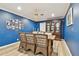 Bright dining room features a rustic wooden table, wicker chairs, and a statement blue wall at 1521 Leighton Ave, Lakeland, FL 33803