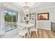 Dining room with white table and chairs, chandelier, and access to backyard at 1521 Leighton Ave, Lakeland, FL 33803