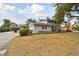 Two-story house with gray brick exterior, attached garage, and landscaped yard at 1521 Leighton Ave, Lakeland, FL 33803