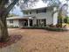 Two-story house with gray brick exterior, landscaped yard, and walkway at 1521 Leighton Ave, Lakeland, FL 33803