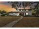 Two-story house with gray brick exterior, landscaped yard, and walkway at 1521 Leighton Ave, Lakeland, FL 33803