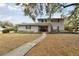 Two-story house with gray brick exterior, landscaped yard, and walkway at 1521 Leighton Ave, Lakeland, FL 33803