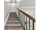 Indoor staircase with carpeted steps and metal railing at 1521 Leighton Ave, Lakeland, FL 33803