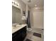 Bathroom with tub, toilet, and dark vanity at 1559 Carey Palm Cir, Kissimmee, FL 34747