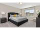 Spacious bedroom with king-size bed, nightstands, and large window at 1559 Carey Palm Cir, Kissimmee, FL 34747