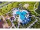 Aerial view of a large, freeform community pool with surrounding landscaping at 1559 Carey Palm Cir, Kissimmee, FL 34747