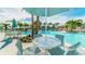 Poolside seating area with tables and umbrellas at 1559 Carey Palm Cir, Kissimmee, FL 34747