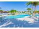 Community pool with seating and shade umbrellas at 1559 Carey Palm Cir, Kissimmee, FL 34747