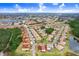 Aerial view showing townhome location in community with surrounding landscape and nearby school at 16202 Indian Creek Dr # 16202, Kissimmee, FL 34759