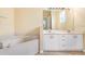 Bathroom boasts a corner bathtub and double vanity at 16202 Indian Creek Dr # 16202, Kissimmee, FL 34759