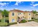 Tan two-story building with red staircases, surrounded by landscaping at 16202 Indian Creek Dr # 16202, Kissimmee, FL 34759