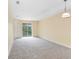 Spacious living room with neutral carpeting and sliding glass doors at 16202 Indian Creek Dr # 16202, Kissimmee, FL 34759