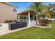 Outdoor kitchen, pool, and lounge area create a relaxing backyard oasis at 1665 Blue Heron Ln, Lakeland, FL 33813