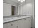 Bathroom features granite countertop, white cabinets, and double sinks at 1665 Blue Heron Ln, Lakeland, FL 33813