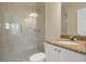 Bathroom boasts a glass shower, granite countertop, and white cabinets at 1665 Blue Heron Ln, Lakeland, FL 33813