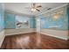 Bedroom with hardwood floors, world map mural, and access to bathroom at 1665 Blue Heron Ln, Lakeland, FL 33813