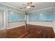 Bedroom with hardwood floors and a world map mural on the walls at 1665 Blue Heron Ln, Lakeland, FL 33813