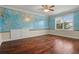 Bedroom with hardwood floors, world map mural, and built-in drawers at 1665 Blue Heron Ln, Lakeland, FL 33813