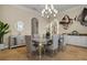 Bright dining room featuring a glass-top table, chandelier, and built-in cabinetry at 1665 Blue Heron Ln, Lakeland, FL 33813