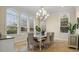 Formal dining room with a large chandelier, elegant table, and comfortable seating at 1665 Blue Heron Ln, Lakeland, FL 33813