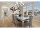 Elegant dining room featuring a glass-top table, chandelier, and large windows at 1665 Blue Heron Ln, Lakeland, FL 33813