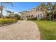 Two-story house with a brick driveway and manicured lawn at 1665 Blue Heron Ln, Lakeland, FL 33813