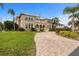 Two-story house with a brick driveway and manicured lawn at 1665 Blue Heron Ln, Lakeland, FL 33813