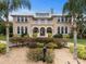 Grand two-story house with a metal roof and landscaping at 1665 Blue Heron Ln, Lakeland, FL 33813