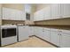 Bright laundry room with white cabinets and modern washer and dryer at 1665 Blue Heron Ln, Lakeland, FL 33813