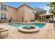 Resort-style pool and spa with covered patio and outdoor kitchen at 1665 Blue Heron Ln, Lakeland, FL 33813