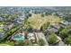 Aerial view of community pool, playground, and homes at 178 Magneta Loop, Auburndale, FL 33823