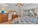 Bedroom with two twin beds, dresser, and ceiling fan at 178 Magneta Loop, Auburndale, FL 33823