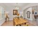 A sunlit dining area with a long wooden table and hardwood floors at 178 Magneta Loop, Auburndale, FL 33823