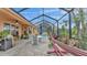 Relaxing screened patio with dining area, hammock, and string lights at 178 Magneta Loop, Auburndale, FL 33823