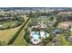 Community pool and clubhouse with surrounding landscape at 1832 Prima Vista Dr, Lakeland, FL 33810