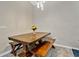 Dining area with a wooden table, benches, and a vase of flowers at 1832 Prima Vista Dr, Lakeland, FL 33810