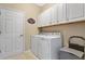 Laundry room with washer, dryer and cabinets at 1832 Prima Vista Dr, Lakeland, FL 33810