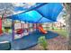 Community playground featuring colorful play equipment under a shade sail at 1832 Prima Vista Dr, Lakeland, FL 33810