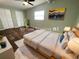 Virtually staged bedroom with wood-look floors and large windows at 1914 Alexander Dr, Lakeland, FL 33803