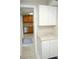 View of kitchen with white cabinets and granite countertops at 1914 Alexander Dr, Lakeland, FL 33803