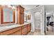 Double vanity bathroom with wood cabinets and a large mirror at 2105 Normandy Heights Ln, Winter Haven, FL 33880