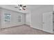 Bedroom with plush carpet, neutral paint, and natural light from two windows at 212 Kissengen Park Dr, Bartow, FL 33830